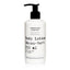 White body lotion bottle with black pump and text on a white background