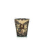 Candle in a decorative container with a pattern on a white background